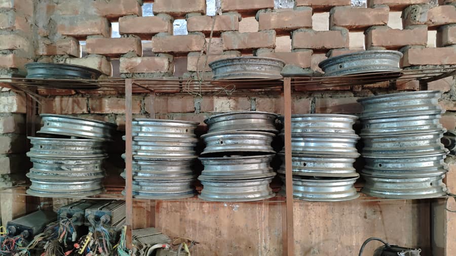 Used wheel rims stacked on shelves