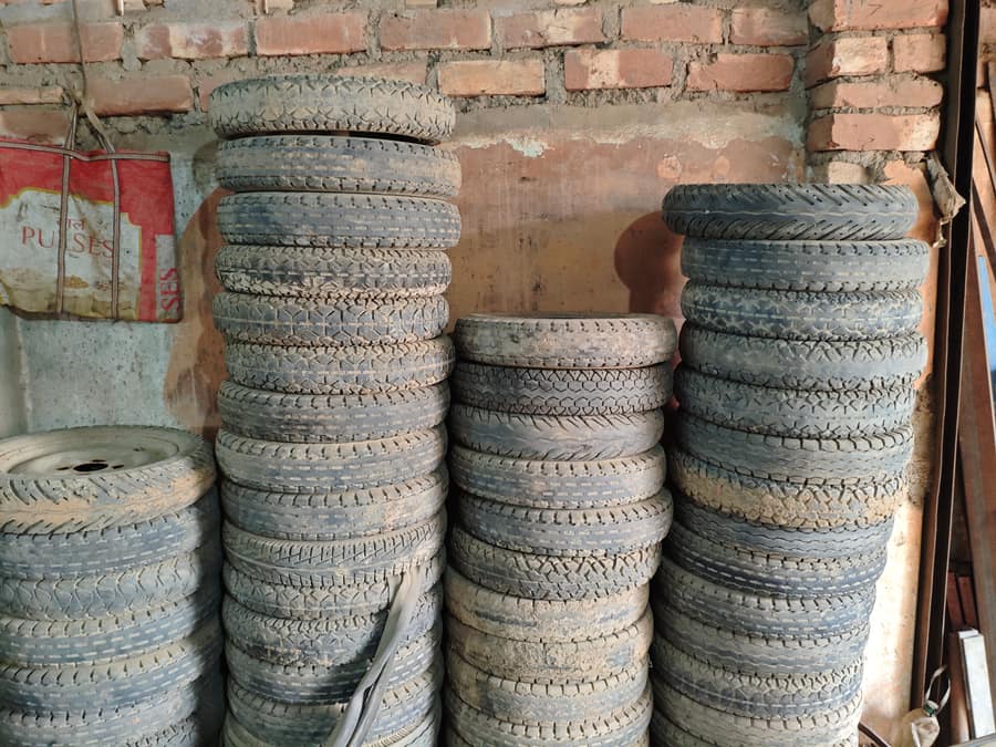 Used e-rickshaw tyres stacked
